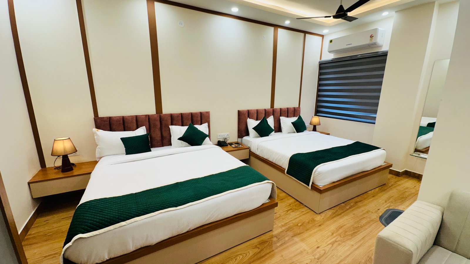 The Premium King Garden View Room at The Ummed Ahmedabad featuring a spacious interior with warm lighting and a king size bed facing the TV mounted on the wall